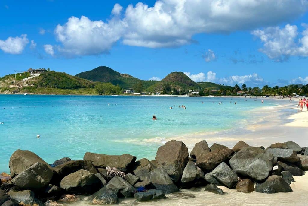 Jolly Harbour Beach with people swimming as it is a safe beach to swim at in Antigua