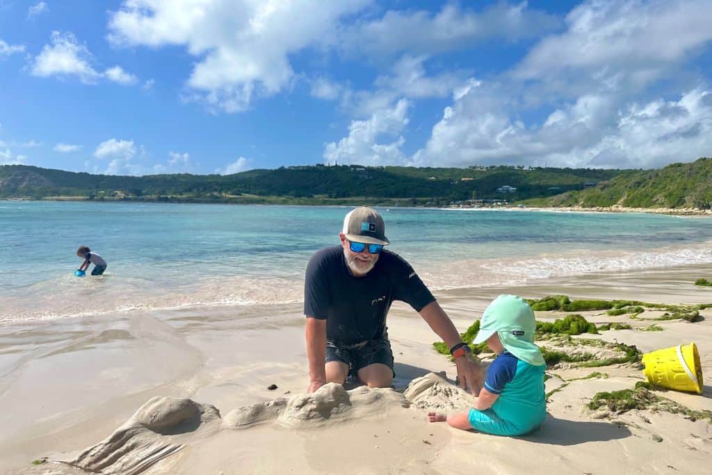 Dad on beach with his baby and toddler in Antigua