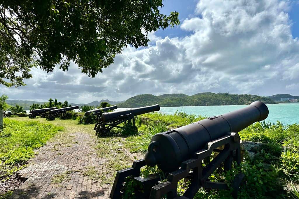 Cannons on a fort wall at St James Fort overlooking the sea