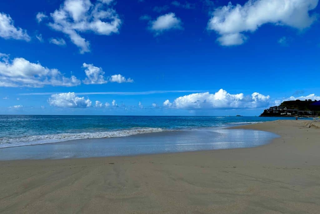 Darkwood Beach in Antigua with golden sands and blue sea. There is no one on the beach.