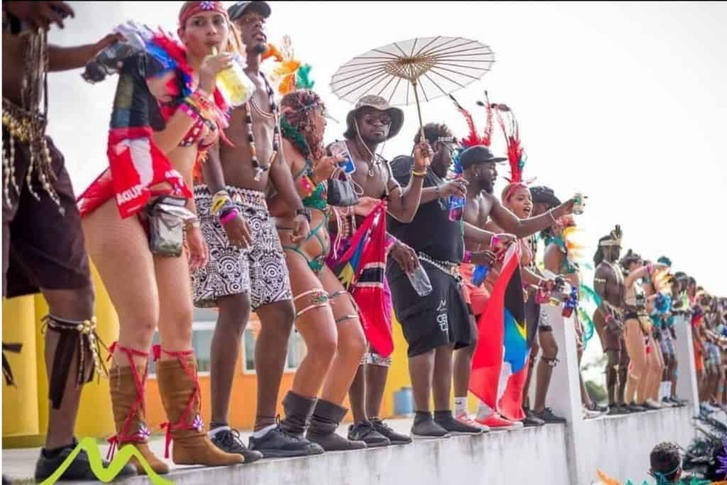 A crowd of people in their parade clothes at Antigua Carnival 
