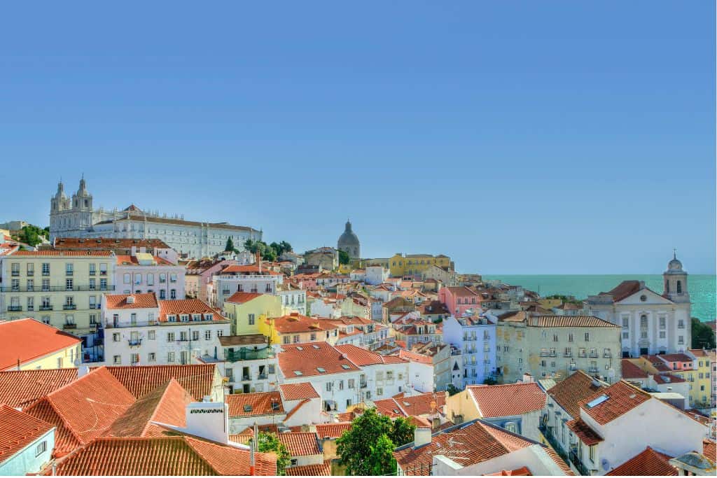 The view over Alfama with the brightly coloured buildings and their red roofs.