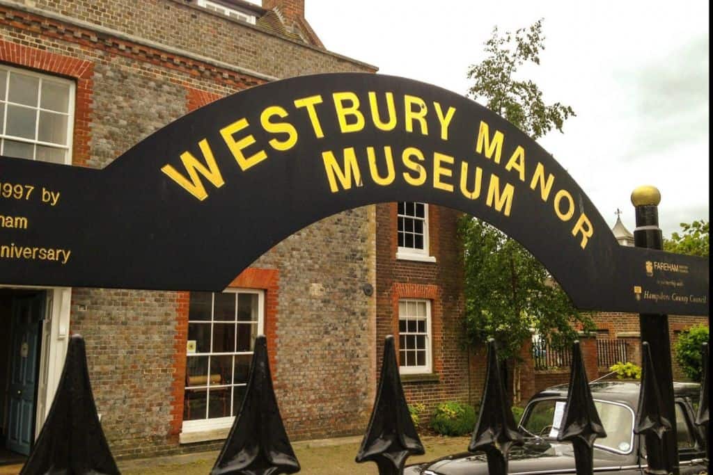 The outside black curved sigh with gold writing spelling Westbury Manor Museum.  This is one of the best free things to do in Hampshire