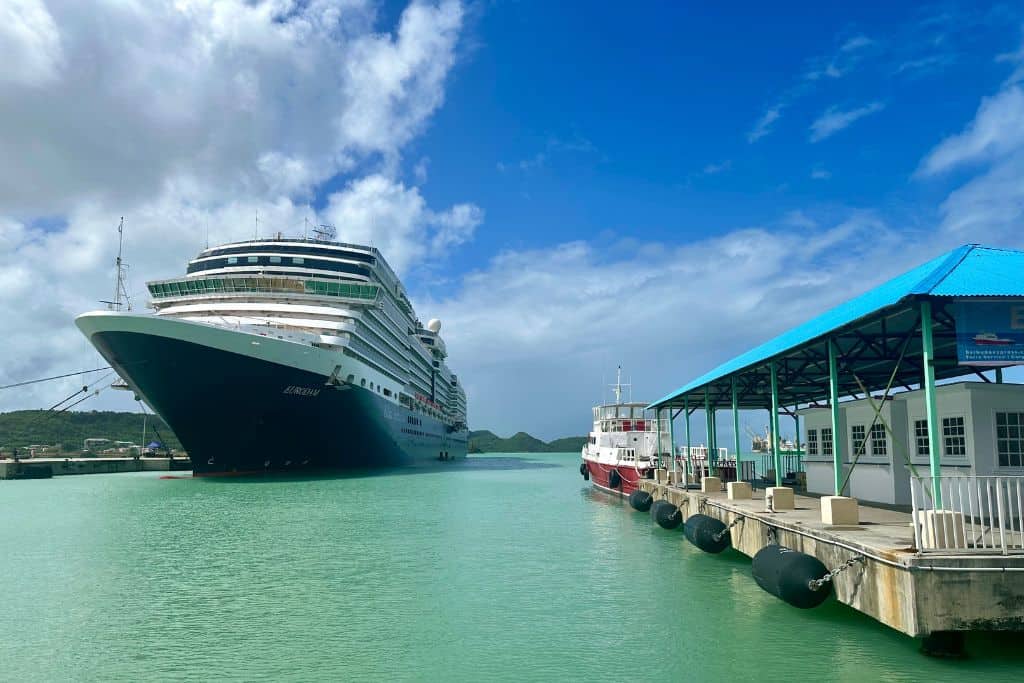 A large cruise ship docked at the Antigua cruise port with the Barbuda Express ferry terminal next to it.
