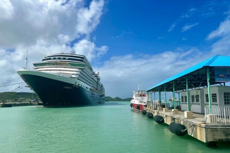 A large cruise ship docked in Antigua cruise port with the Barbuda ferry terminal next to it.