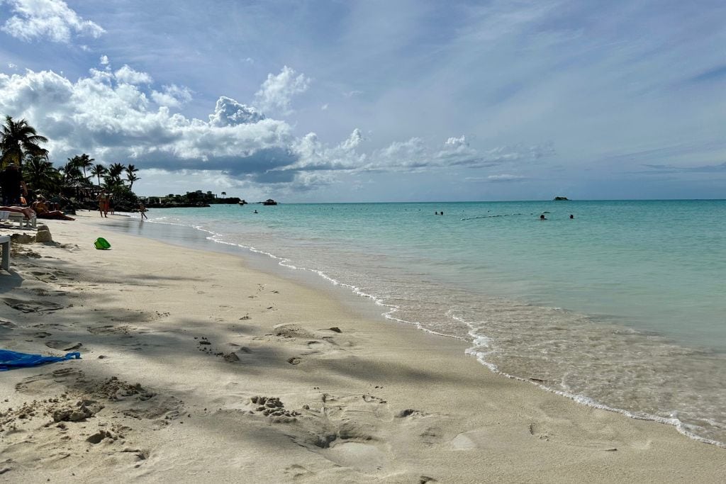 The white sands and clear blue waters of Dickenson Bay which is one of the nearest beaches to Antigua cruise port.