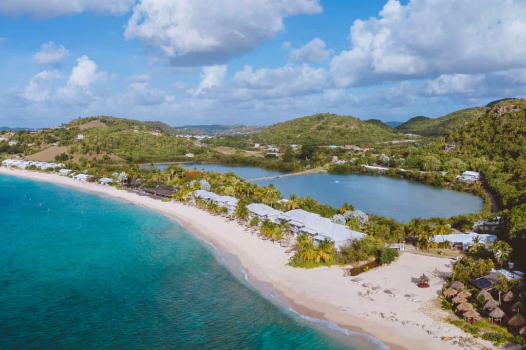 The view over the Galley Bay Resort and Spa where you can see the beach and then on the other side of some trees the lagoon.  Stunning white sands on one side and lush trees and lagoon on the other