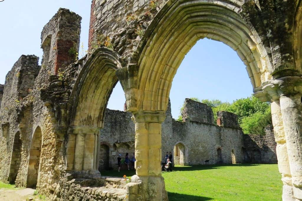 The ruins of an old abbey with stone arches.  This is Netley Abbey one of the best free things to do in Hampshire.