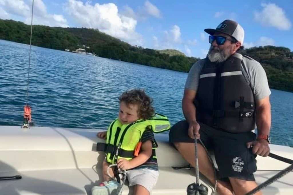 A father and son dinghy sailing at the National Sailing Academy in Antigua.