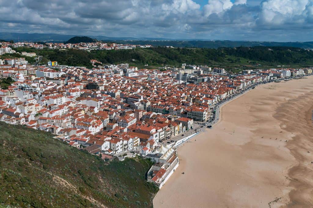 The view from the fort of the Praia da Nazare beach with the town behind it.  Lisbon to Nazare is a popular day trip.