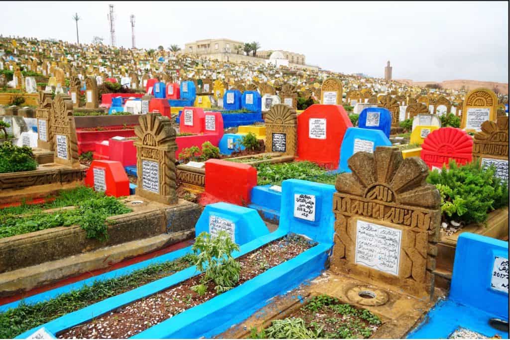 This is an image of grace stones of various differnt bright colours such as red, green, yellow and blue.  This is the cemetery in Rabat in Morocco and is one of the things to do in Rabat that you shouldn't miss out on seeing. 