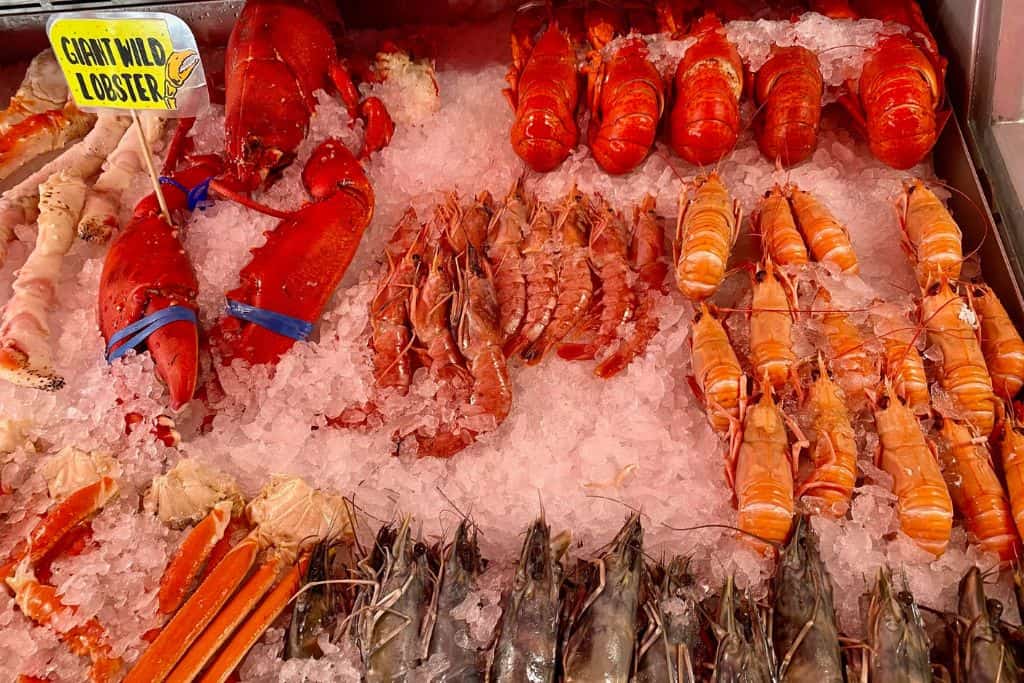 This is a tray of a seafood that is from the Bergen fish market.  There are lobster, shrimps amongst other things.