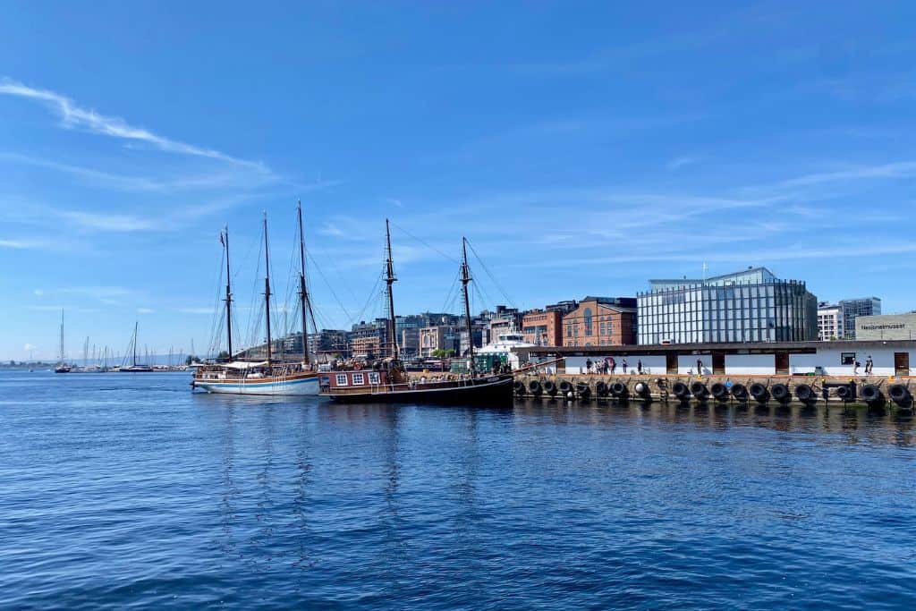 An image of the waterfront in Oslo with some tour ships coming and going for the day. This is one of the things that you should try if you have one day in Oslo.