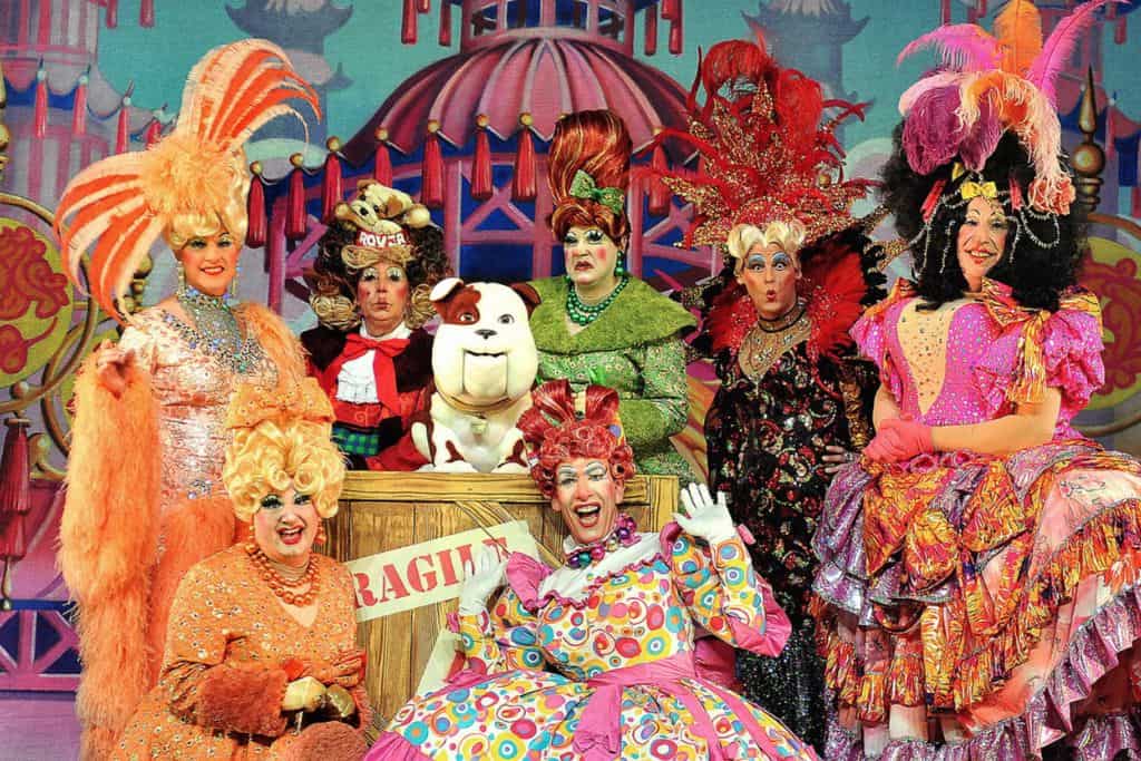 This is a promotional image taken from a Christmas patomime.  In the middle are seven characters all dressed up to perform. 