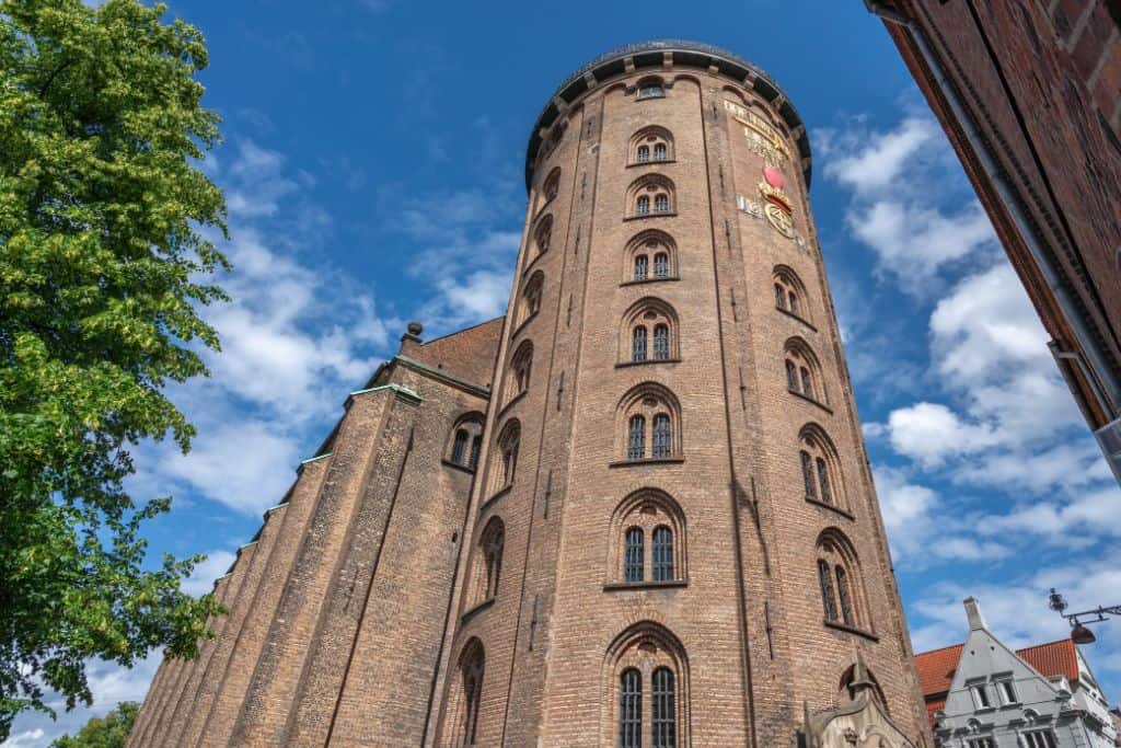 A photo taken looking up from the bottom of The Round Tower in Copenhagen where you are looking along the windows and up to the top.