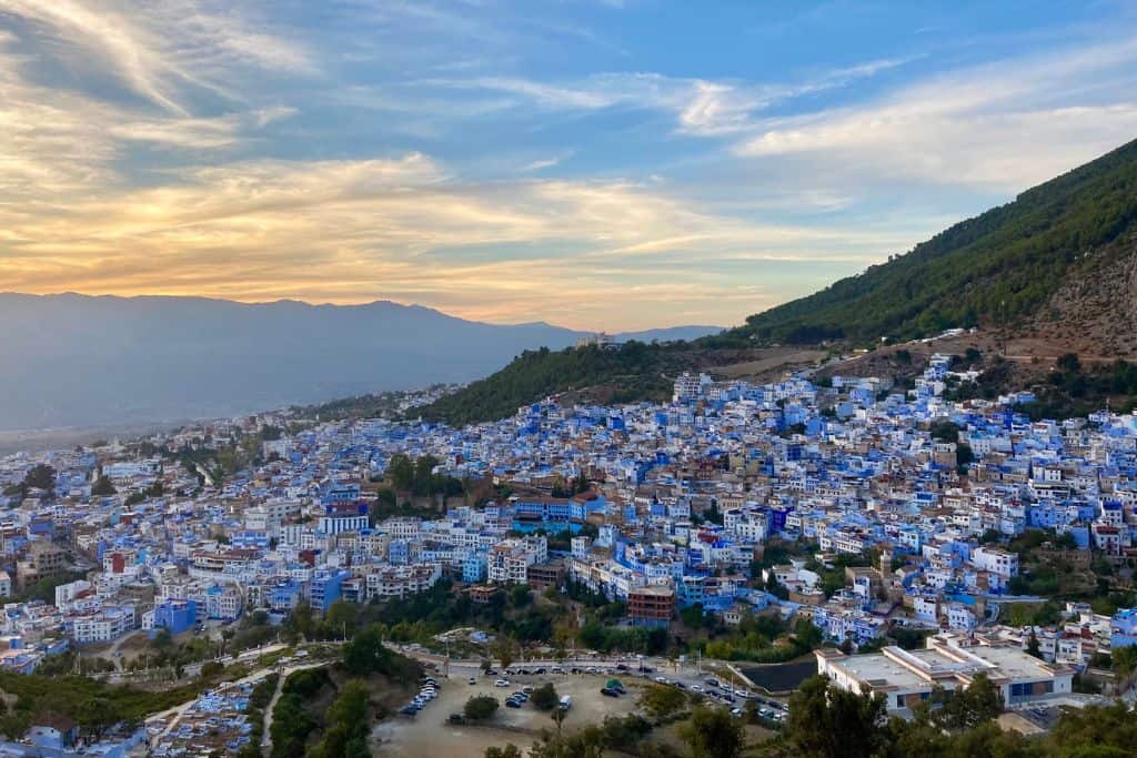 This photo was taken as the sunsets over the blue city of Chefchaouen. It was a cloudy day so the sun wasn't clear, however, it is still magical to see the blue buildings lit up as the sun sets.  It is definitely worth visiting the Spanish Mosque which is where the photo was take from.